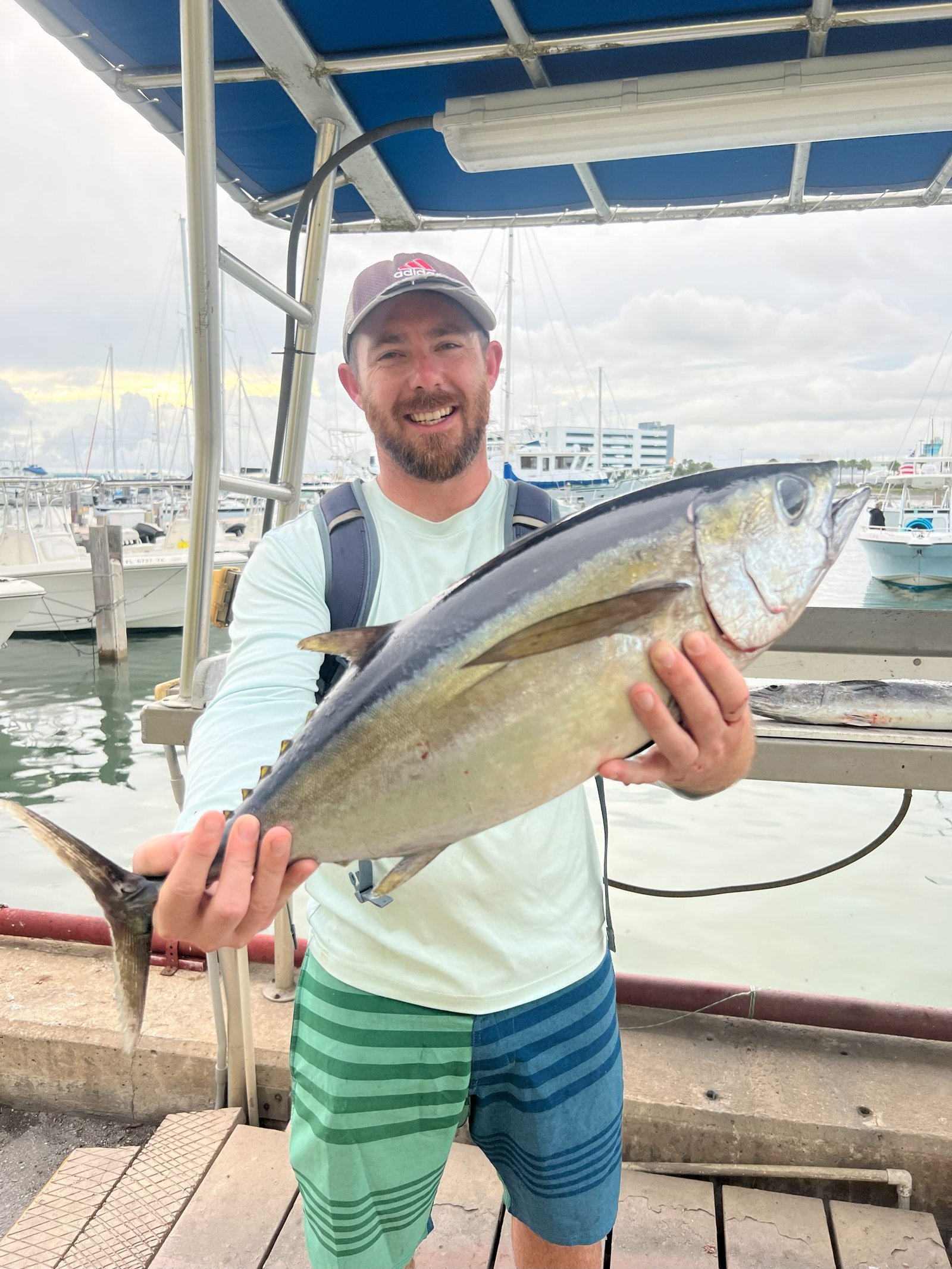 man holding blackfin tuna he caught Florida fishing